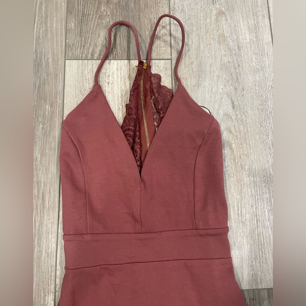 Burgundy dress with zipper on back. Never worn, no tags attached.
